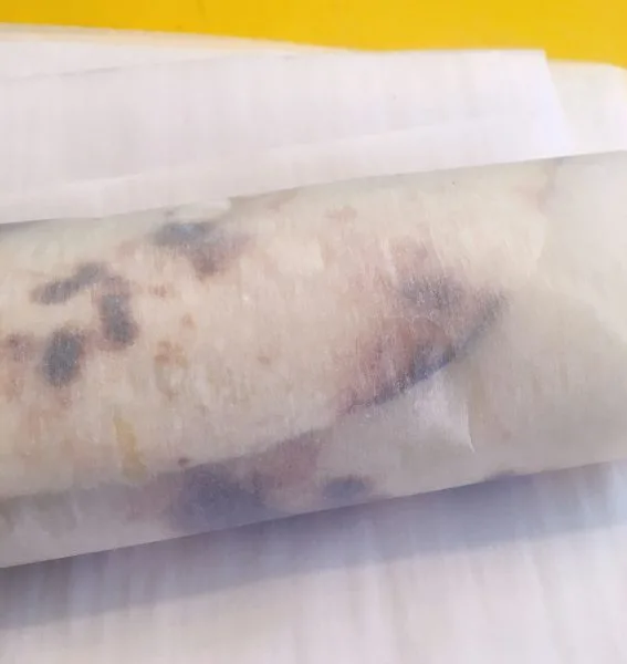 Breakfast Burrito wrapped in parchment paper