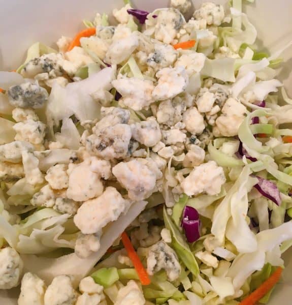 Medium serving bowl with shredded cabbage and blue cheese