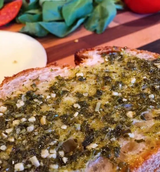 Slice of bread of Pesto spread on it.