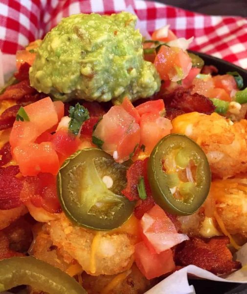 Golden Crispy Tater Crowns loaded with cheese, bacon, guacamole, pico and jalapenos