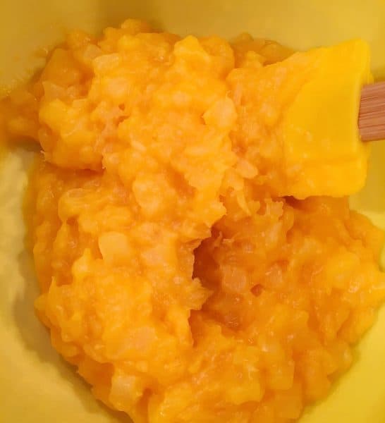 Yellow bowl with one package of vanilla pudding mixed with one and half cups of undrained pineapple