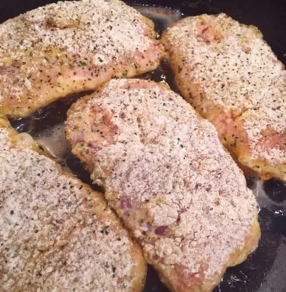 Fry pan with Olive Oil and Coated Pork Chops