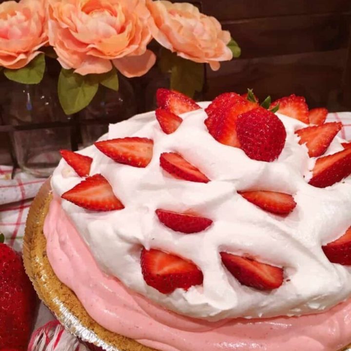 Strawberry Cream Pie decorated with fresh sliced strawberries in a pie crust.