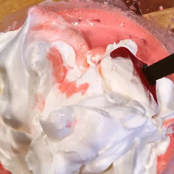 Cool Whip being folded into cream mixture