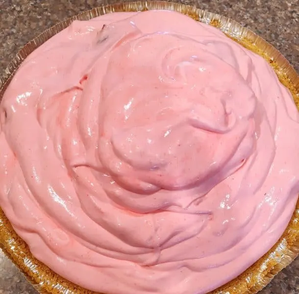Strawberry Cream Pie filling poured into crust