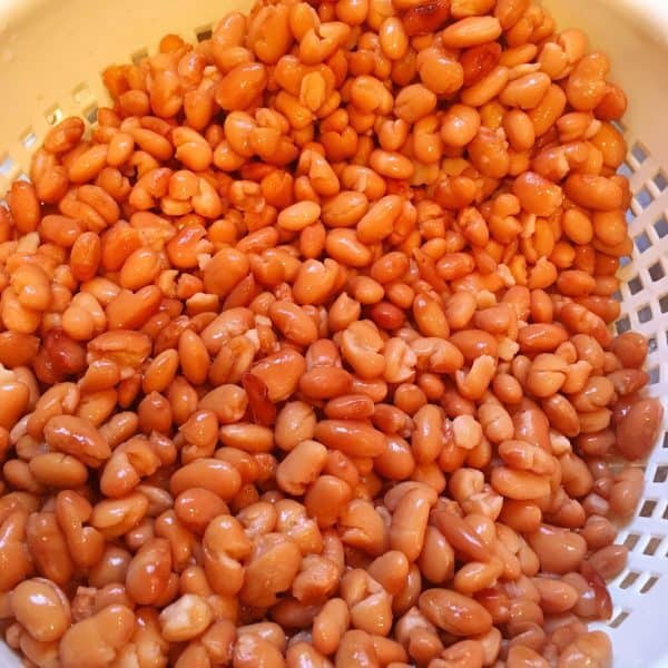 Pinto beans being rinsed and drained