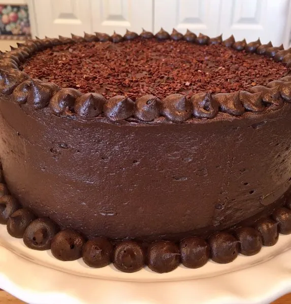 Dark Chocolate Cake decorated on a cake stand