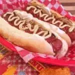 Two Grilled Seattle Dogs in a red basket.