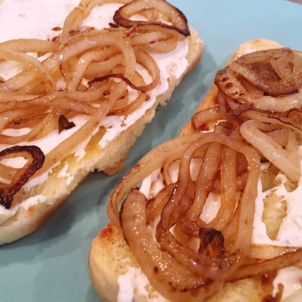 Hot dog buns with cream cheese and caramelized onions