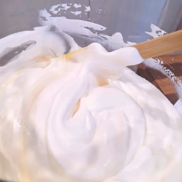 mixing whipping cream and sweetened condensed milk together