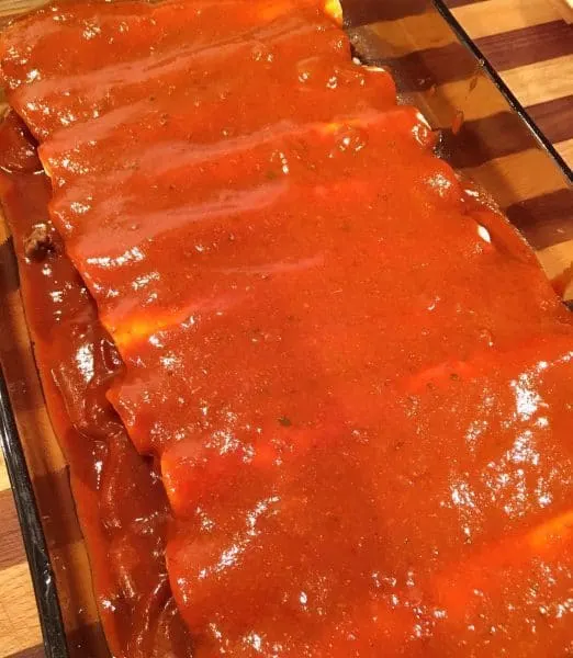 Easy Ground Beef Enchiladas covered in sauce