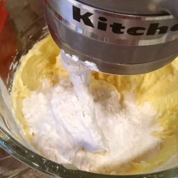 Flour mixture being added to creamed mixture