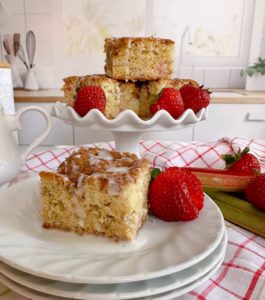 Rhubarb Sour Cream Coffee cake on a serving plate and piled high on a cake plate.