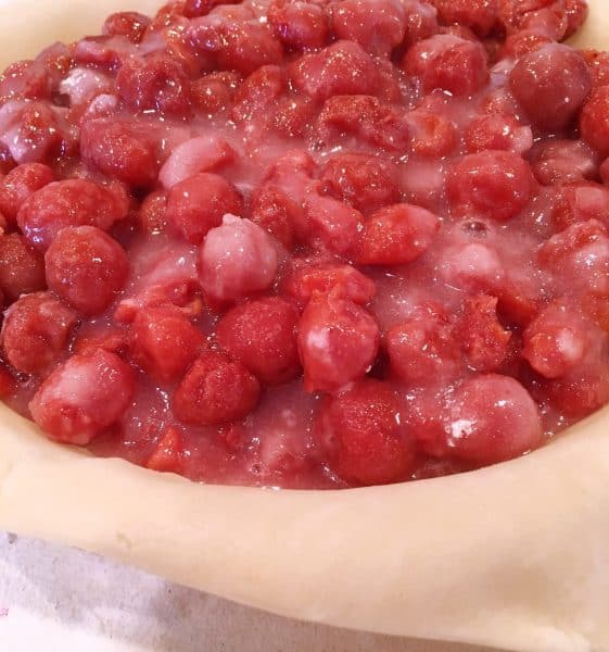 pastry line pie plate with cherry pie filling