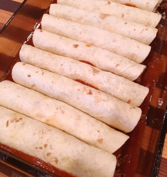 pan full of rolled enchilada's