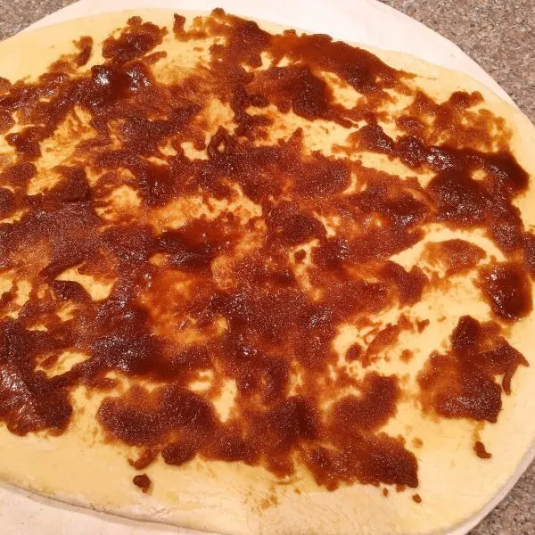 Cinnamon mixture on roll dough