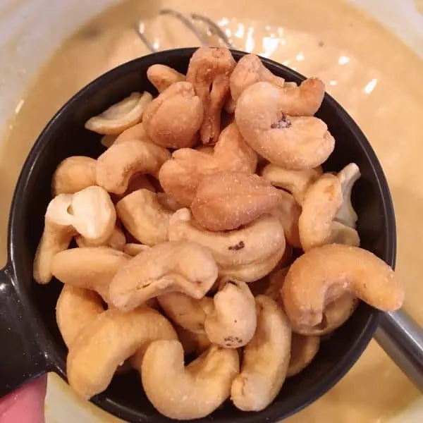 Cashews being added to the soup mixture