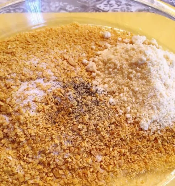 Bowl with corn flake crumbs, salt, pepper, and parmesan cheese