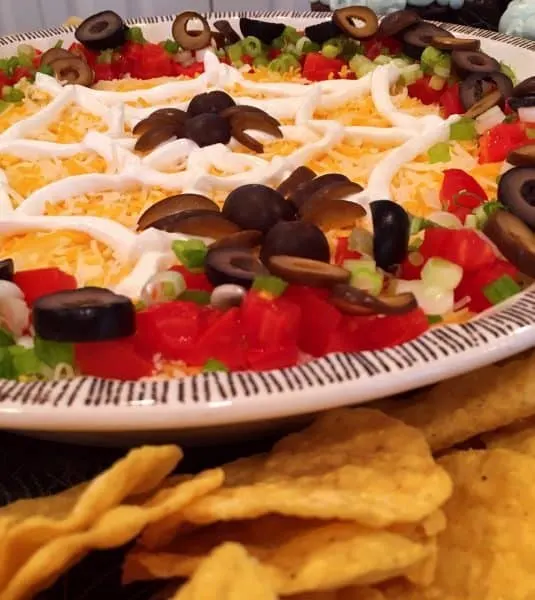 Spooky Halloween Seven Layer Taco Dip with corn chips