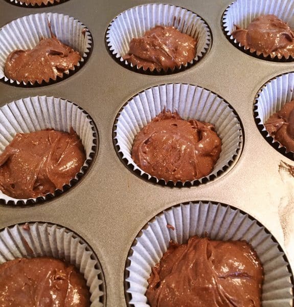 Muffin tin lined with papers and filled 2/3 full of cake batter