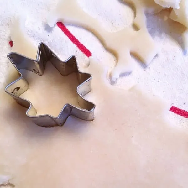 Leaves and acorns being cut out of pie crust.