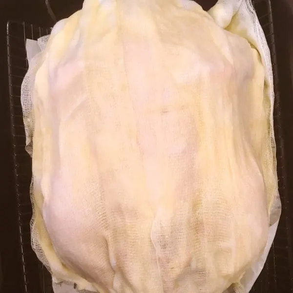 Turkey covered in wine coated cheesecloth