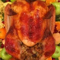 Turkey on a platter with stuffing and garnish