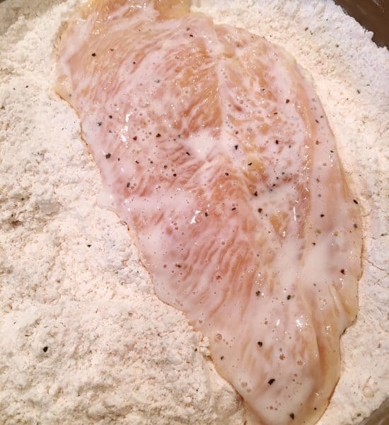 Dredge chicken in flour mixture