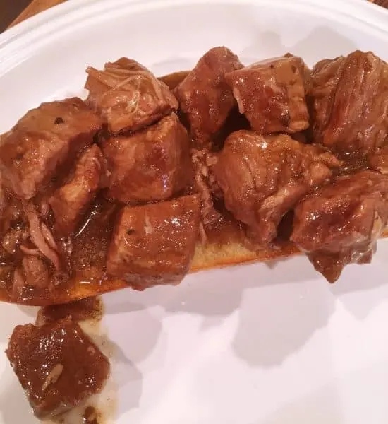 Hot beef and gravy on top of sour dough bread