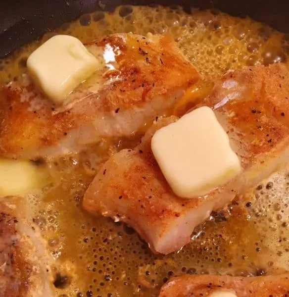 Adding extra butter to cod
