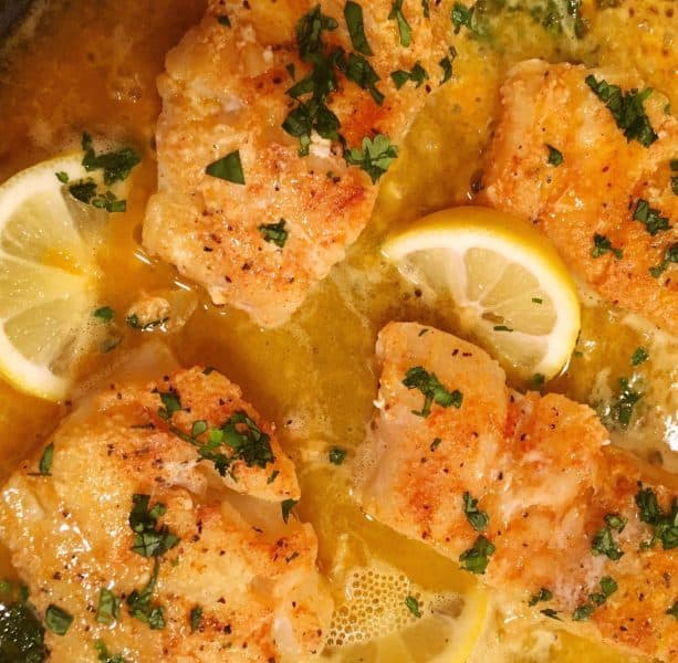 Butter Cod in skillet with herbs and lemon