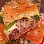 Cheesesteak Sliders stacked on a checkered paper