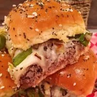 Cheesesteak Sliders stacked on a checkered paper