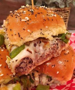 Cheesesteak Sliders stacked on a checkered paper