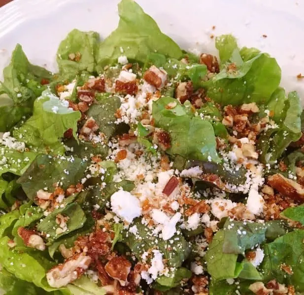 Lettuce topped with cheese and nuts