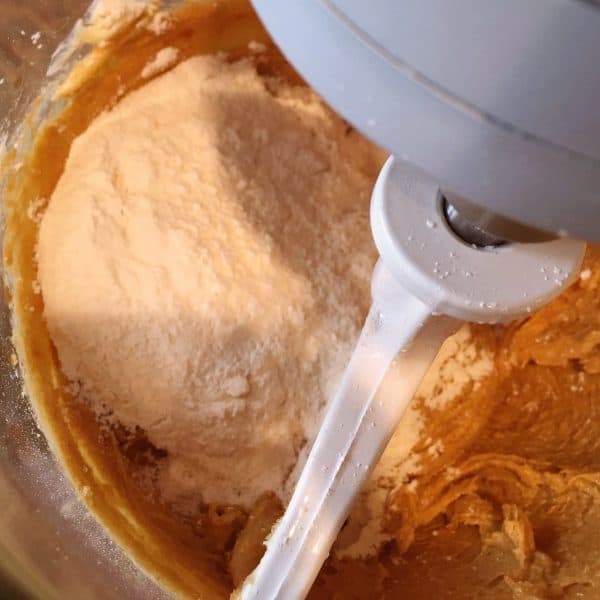 adding flour mixture to creamed mixture