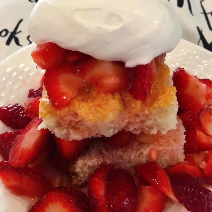 Serving of Strawberry Shortcake with a big dollop of whipped cream.