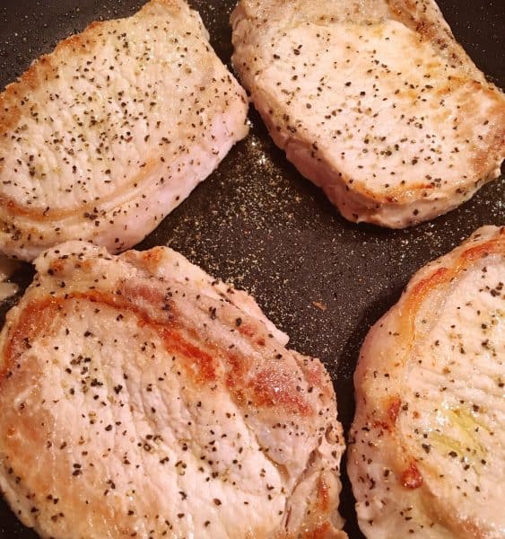 Pork Chops cooking in skillet