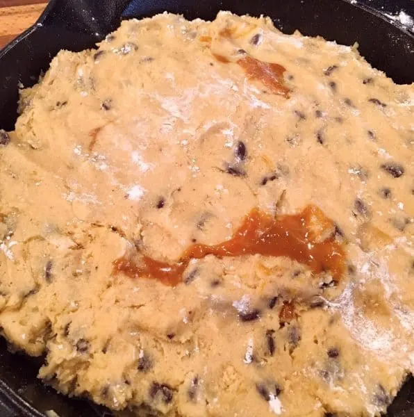Adding remaining cookie dough over caramel