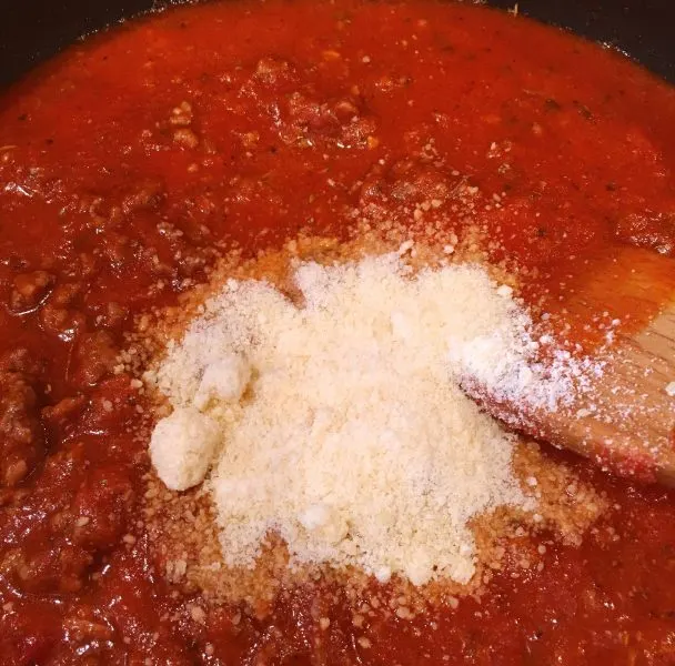 Add grated parmesan cheese to sauce