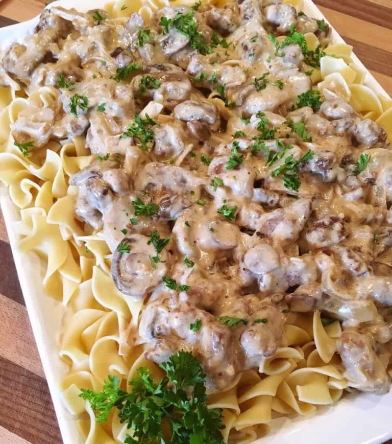 Platter of Beef Stroganoff with a sprinkling of fresh chopped parsley.