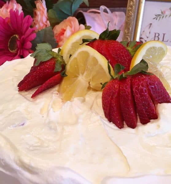 Cake topped with strawberries and lemon slices