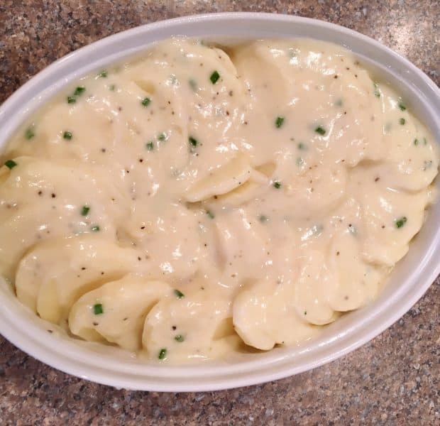 Potatoes and cream sauce in baking dish