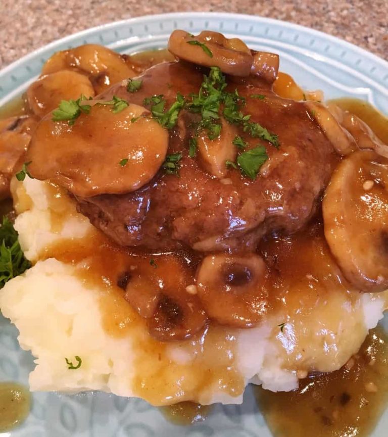 Salisbury Steak on top of mashed potatoes.