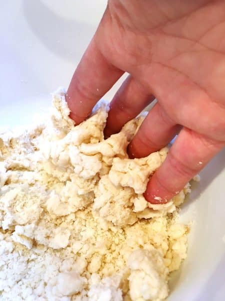 Using fingers to gather the dough