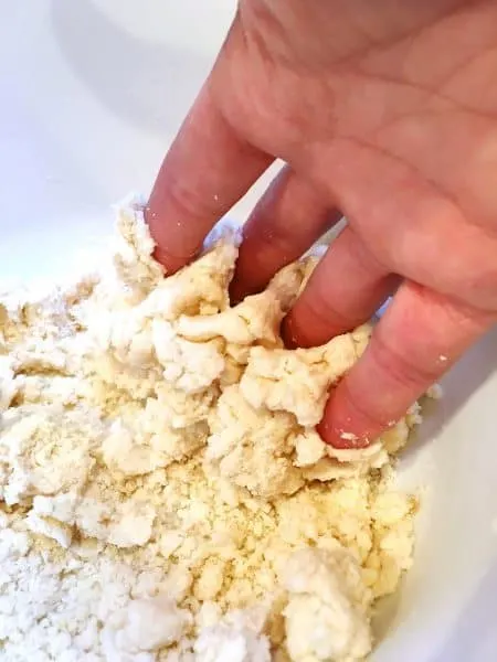 Using fingers to gather the dough