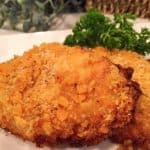 Two Oven Fried Butter Crumb Pork Chops on a white plate ready to eat!