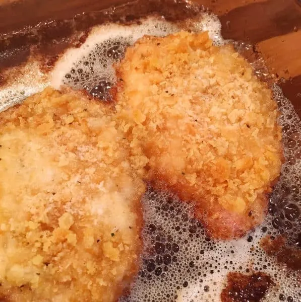 Oven Fried Butter Crumb Pork Chops in baking pan crispy brown.