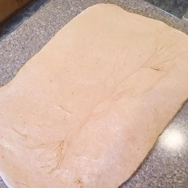 Carrot Cake Cinnamon Roll dough rolled out into a rectangle.