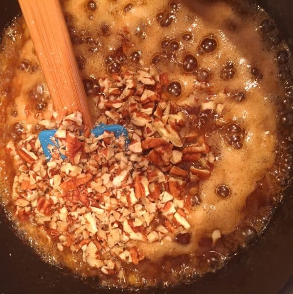 Adding chopped pecans to carrot cake mix cinnamon roll filling.